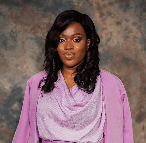 Grace Heneovai Japheth, Founder of The Builders Institute, in a lavender outfit against a textured backdrop